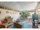 Cozy outdoor patio featuring wicker furniture, a ceiling, and a small beverage refrigerator at 12234 Cider Mill Ln, Hudson, FL 34667