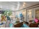 Inviting patio with wicker seating, glass table, and tranquil decor, adjacent to the door at 12234 Cider Mill Ln, Hudson, FL 34667