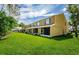 Townhome with backyard featuring green grass and porches at 1241 Redondo Way, Wesley Chapel, FL 33543