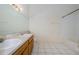 Bathroom featuring double sinks, a bathtub, and white tile flooring at 1241 Redondo Way, Wesley Chapel, FL 33543