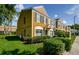 Charming multi-story townhouse featuring a well-maintained lawn and lush green bushes at 1241 Redondo Way, Wesley Chapel, FL 33543