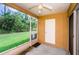 Enclosed porch with ceiling fan, screen windows and door at 1241 Redondo Way, Wesley Chapel, FL 33543