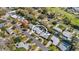 An aerial view shows the home with pool, screened in patio, and landscaped back yard in a quiet neighborhood at 1320 Dixie S Ln, St Petersburg, FL 33707