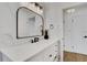 Bright bathroom with marble-look walls, vanity, black hardware, and modern lighting at 1320 Dixie S Ln, St Petersburg, FL 33707