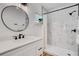 Bathroom showcasing black fixtures, a glass shower, and a sink with storage space at 1320 Dixie S Ln, St Petersburg, FL 33707