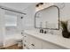 Bright bathroom with marble-look shower, vanity, black hardware, and modern lighting at 1320 Dixie S Ln, St Petersburg, FL 33707