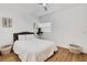 Bright bedroom with neutral decor, fan, wood-look floors, and natural light at 1320 Dixie S Ln, St Petersburg, FL 33707