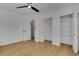 Bedroom featuring light wood floors, neutral paint, a closet, and access to other rooms at 1320 Dixie S Ln, St Petersburg, FL 33707