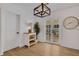 Bright entryway with french doors, stylish light fixture, wood-look floors, and decorative accents at 1320 Dixie S Ln, St Petersburg, FL 33707