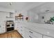 Bright white kitchen featuring stainless steel appliances, wooden accents, and quartz countertops at 1320 Dixie S Ln, St Petersburg, FL 33707