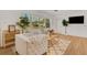 Cozy living room with comfortable seating, a large window, and views of the well landscaped front yard at 1320 Dixie S Ln, St Petersburg, FL 33707