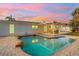 Sparkling pool surrounded by a brick paver patio and covered outdoor seating area, perfect for relaxation at 1320 Dixie S Ln, St Petersburg, FL 33707