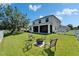 Spacious backyard featuring a fire pit, screened porch, and white picket fence at 13252 Graham Yarden Dr, Riverview, FL 33579