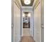 A hallway leading to a bathroom featuring double sinks, vanity, and plenty of light at 13252 Graham Yarden Dr, Riverview, FL 33579
