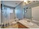 Cozy bathroom featuring a single sink vanity, toilet, and a shower-tub combo with stylish curtain at 13252 Graham Yarden Dr, Riverview, FL 33579