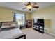 Bedroom featuring a large window, ceiling fan, and comfortable furnishings, creating a cozy retreat at 13252 Graham Yarden Dr, Riverview, FL 33579