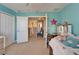 Well-lit bedroom with aqua walls, doorway to hallway, and comfortable bed creating a cozy space at 13252 Graham Yarden Dr, Riverview, FL 33579