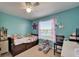 Bright bedroom featuring a large window, ceiling fan, and comfortable furnishings, creating a cozy retreat at 13252 Graham Yarden Dr, Riverview, FL 33579