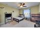 Bedroom featuring a large window, ceiling fan, and comfortable furnishings, creating a cozy retreat at 13252 Graham Yarden Dr, Riverview, FL 33579