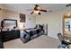 Bedroom featuring a large window, ceiling fan, and comfortable furnishings, creating a cozy retreat at 13252 Graham Yarden Dr, Riverview, FL 33579