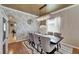 Chic dining room with a long table, modern chandelier, and a stylish geometric wall design at 13252 Graham Yarden Dr, Riverview, FL 33579