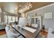 Elegant dining area featuring a long dining table with modern chandelier and stylish decor at 13252 Graham Yarden Dr, Riverview, FL 33579