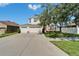 Two-story home with a three car garage, large driveway, and a well-maintained lawn at 13252 Graham Yarden Dr, Riverview, FL 33579