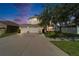 Two-story home with a three car garage, large driveway, and a well-maintained lawn at 13252 Graham Yarden Dr, Riverview, FL 33579