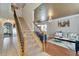 Spacious foyer with staircase and views of the living room featuring elegant decor and hardwood floors at 13252 Graham Yarden Dr, Riverview, FL 33579