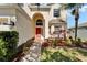 Welcoming front entrance showcases an arched doorway and neatly arranged landscaping at 13252 Graham Yarden Dr, Riverview, FL 33579