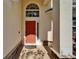 Inviting front entrance with a red door, stylish overhead window, and decorative brick accents at 13252 Graham Yarden Dr, Riverview, FL 33579