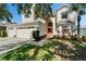Charming two-story home featuring a well-manicured lawn and a front entrance with an arched doorway at 13252 Graham Yarden Dr, Riverview, FL 33579