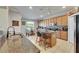 Bright kitchen featuring an island with seating, granite countertops, and modern appliances at 13252 Graham Yarden Dr, Riverview, FL 33579