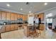 Well-lit kitchen boasts stainless steel appliances, granite countertops, and a central island with bar seating at 13252 Graham Yarden Dr, Riverview, FL 33579