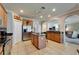 Spacious kitchen featuring stainless steel appliances, a center island with granite, and tiled floors at 13252 Graham Yarden Dr, Riverview, FL 33579