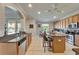 Open-concept kitchen featuring a breakfast bar, stainless appliances, and granite countertops at 13252 Graham Yarden Dr, Riverview, FL 33579