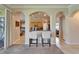 Open living space featuring white archways and barstool seating that faces the kitchen at 13252 Graham Yarden Dr, Riverview, FL 33579