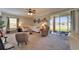 Bright and spacious living room with modern decor, access to a screened lanai, and plush seating at 13252 Graham Yarden Dr, Riverview, FL 33579
