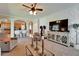 Comfortable living room with white brick wall, ceiling fan, and arched entrance to kitchen at 13252 Graham Yarden Dr, Riverview, FL 33579