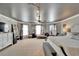 Spacious main bedroom with neutral tones, chaise lounge, bedside tables and lamps, exercise bike, and carpeted floor at 13252 Graham Yarden Dr, Riverview, FL 33579