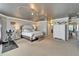 A well-decorated main bedroom with a decorative ceiling, neutral colors, and space for exercise equipment at 13252 Graham Yarden Dr, Riverview, FL 33579