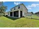 The rear exterior of a two-story home with a screened-in porch and fenced yard at 13252 Graham Yarden Dr, Riverview, FL 33579