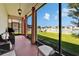 A screened-in porch with comfortable seating and a view of the backyard with fire pit at 13252 Graham Yarden Dr, Riverview, FL 33579
