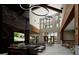 Spacious lobby with a dark marble accent wall, high ceilings, modern lighting, sofas and a TV at 13733 Canyon Ridge Rd, Spring Hill, FL 34610