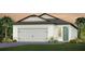 Charming single-story home boasts a two-car garage, lush landscaping, and a welcoming entrance at 13741 Canyon Ridge Rd, Spring Hill, FL 34610