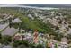 Aerial view of a residential neighborhood, close to bay, with lots of green trees and pond at 1712 Azalea Ct # A, Oldsmar, FL 34677