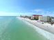 Aerial view of beachfront with resort and condos along white sand and blue ocean at 1712 Azalea Ct # A, Oldsmar, FL 34677