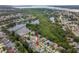Aerial view of a bay-adjacent neighborhood with numerous ponds and lush tree coverage at 1712 Azalea Ct # A, Oldsmar, FL 34677