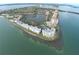 Aerial view of waterfront condos showcasing waterfront views and the surrounding ocean under a blue sky at 1712 Azalea Ct # A, Oldsmar, FL 34677