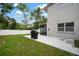 Spacious backyard with white fence, a patio with a grill, and screened in porch at 1712 Azalea Ct # A, Oldsmar, FL 34677